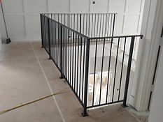 Black steel picket railing along an upper walkway. Railings by RF Iron Works