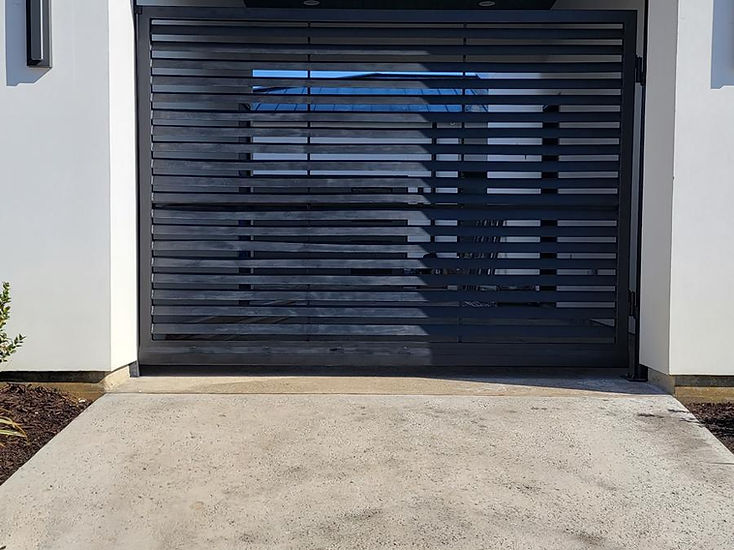 Horizontal-slat steel driveway gate fabricated by RF Iron Works in Anna, TX