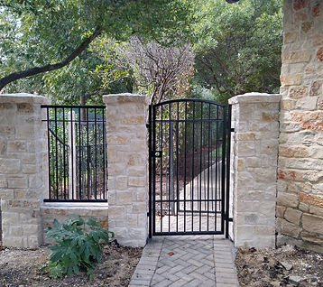Pedestrian iron gate between stone columns