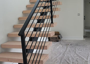Floating steel stair with bar railing