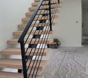 Escalera flotante con viga central y barandal