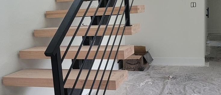 Floating mono-stringer steel stair with bar railing, fabricated by RF Iron Works in Anna, TX