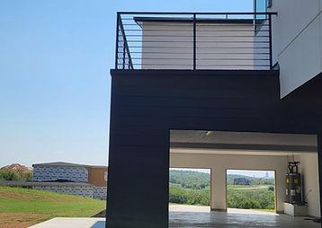 Exterior balcony with black horizontal railing