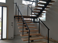 Open-riser switchback stair on steel stringers. Stairs by RF Iron Works
