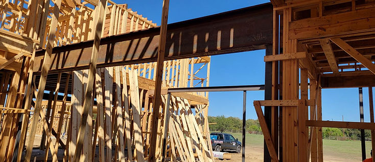 Steel beam set on a wood-framed house by RF Iron Works