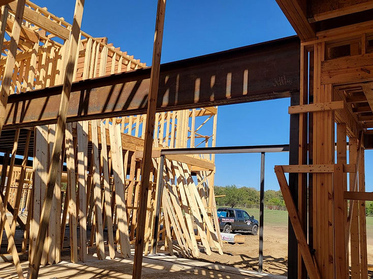 Steel beam set on a wood-framed house by RF Iron Works