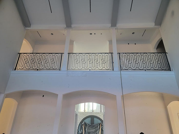Ornamental scroll-pattern balcony railing fabricated by RF Iron Works