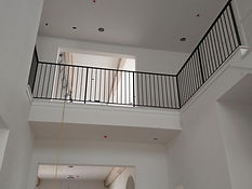 Second-floor overlook railing in black steel. Railings by RF Iron Works