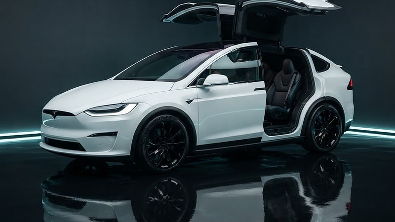 Illustrative render of a white electric SUV with falcon-wing doors open in a dark studio
