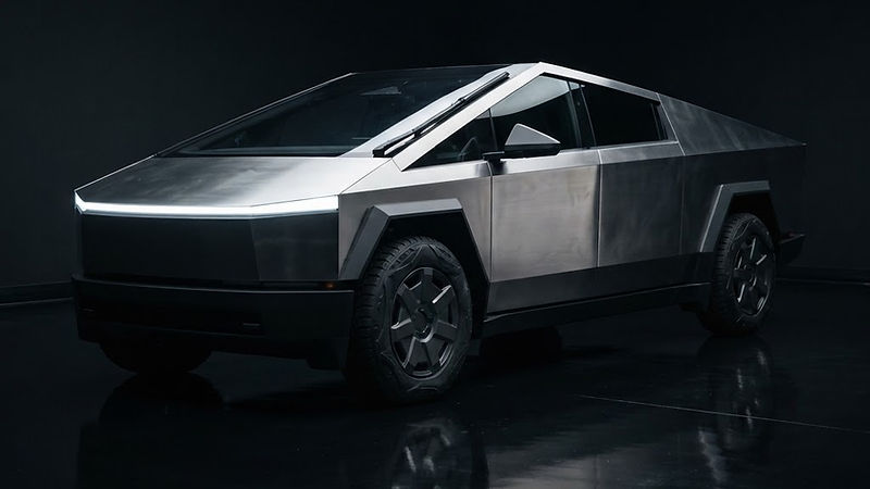 Illustrative render of an angular stainless steel electric pickup truck in a dark studio