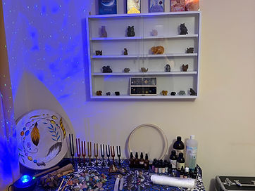 Crystals, tuning forks and essential oils arranged on the treatment table