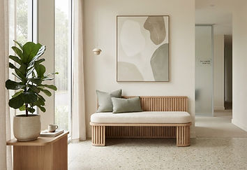 A soft armchair beside a tall window with a view of trees