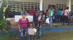 Familias recibiendo sus regalos durante la entrega