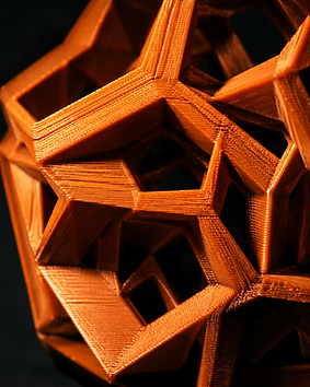 Macro view of a copper 3D printed geometric object showing fine layer lines