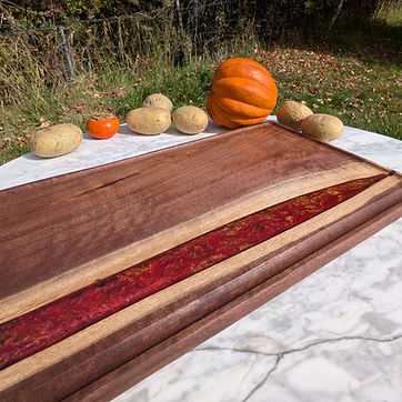 Walnut river board — deep red resin with gold leaf.