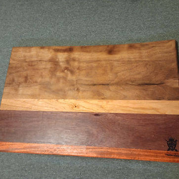 A stripe board in walnut, maple and cherry, signed in the corner.