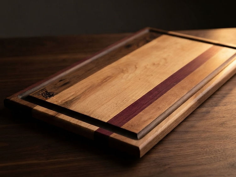 A face grain segmented board with the Masterworks crest in the corner.
