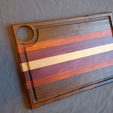 Cherry and bloodwood stripe board with a juice groove run just inside the edge.