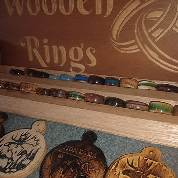 The ring rack at a show, with engraved coasters on the table alongside.