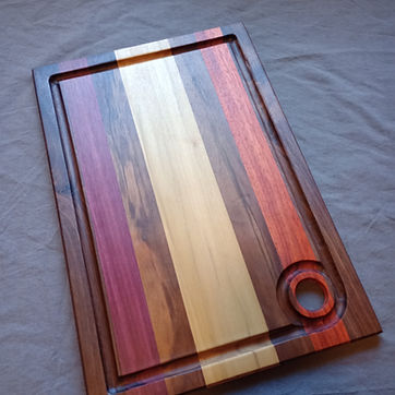 Segmented board — walnut, purpleheart, cherry and maple, with a routed juice groove.