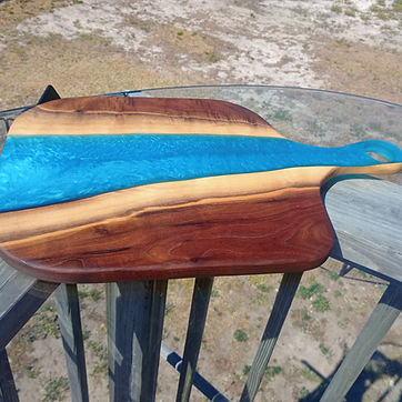 Electric blue river board with a cut handle.