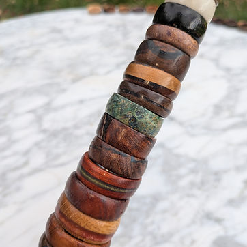 Thirteen more, including a stabilized green burl and one band with a green stripe set in.