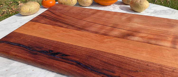 An edge grain walnut board with a darkened border, on marble