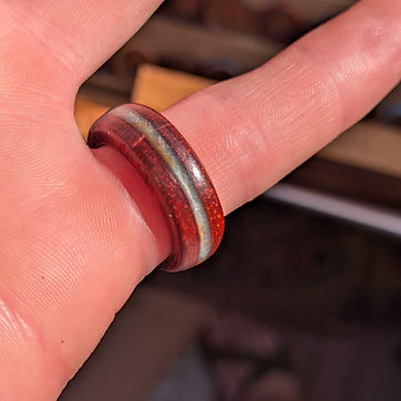 A deep red band with a pale pearl inlay.