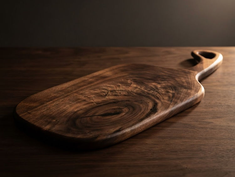 A handled board cut from one solid piece of walnut.