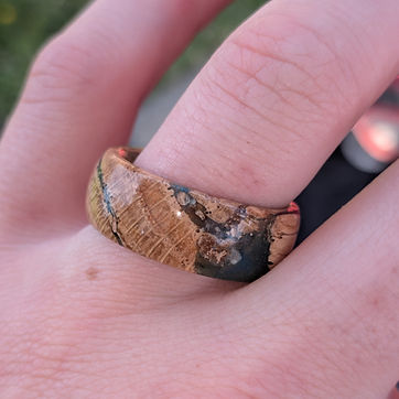 Wood and dark resin, the pour following a natural rift in the grain.