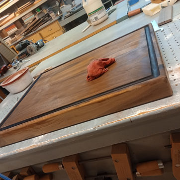 A board on the bench, the recess routed and ready for sanding.