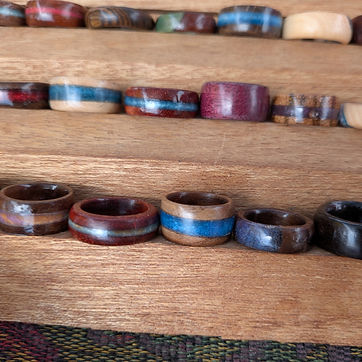 Solid bands and resin rivers, side by side on the rack.