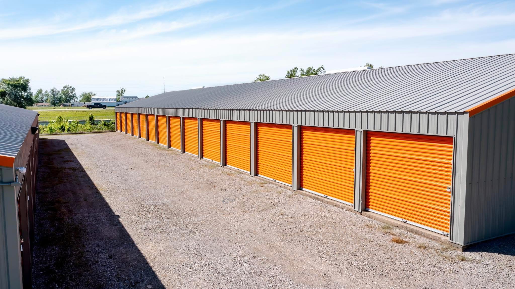 Self-storage facility with orange unit doors, supplied by My Storage Partners