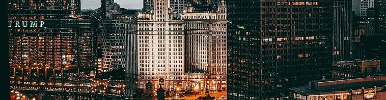 A city skyline along a river at dusk (stock photograph)