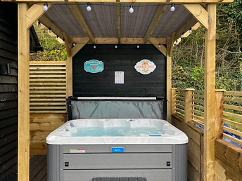 Private hot tub filled with water under the timber pergola