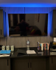 Lydden Bell Lodge television and media wall with dark built-in cabinets
