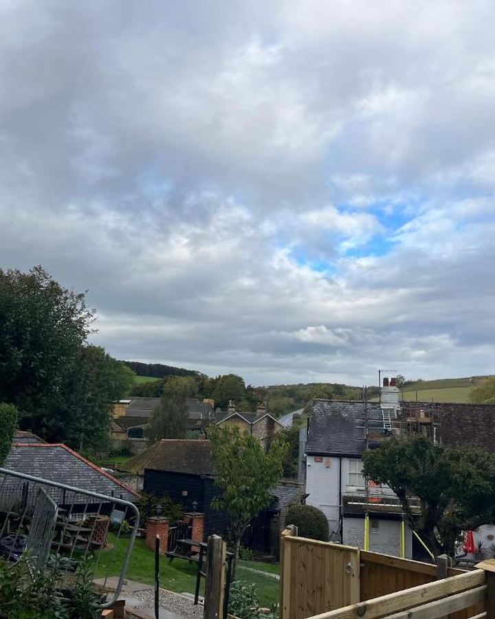 View over green fields and houses in Lydden village, Kent