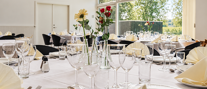 Tables laid with flowers in Lysebergh's bright dining room