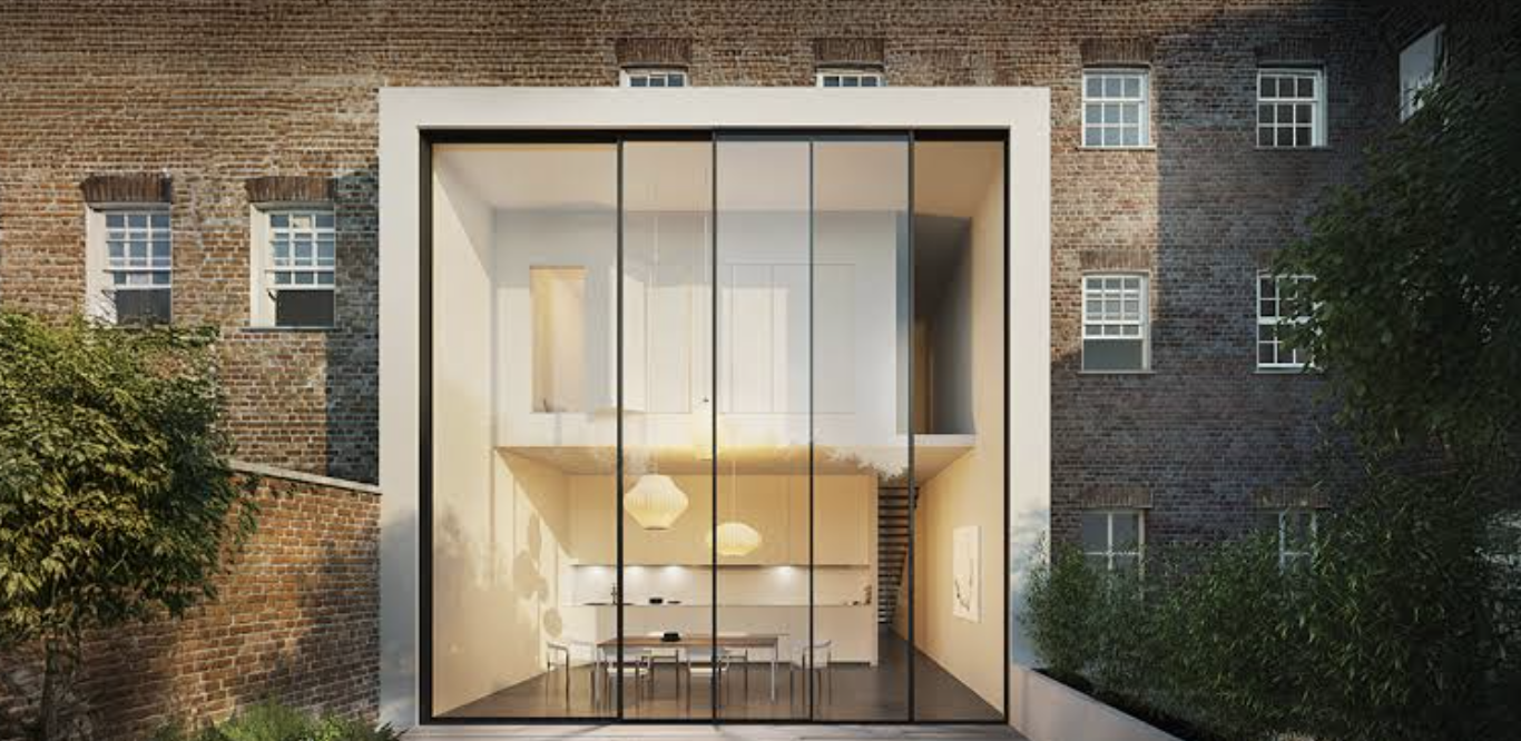 Sliding glass doors set into a white-framed opening in a red-brick house, with a dining space visible inside