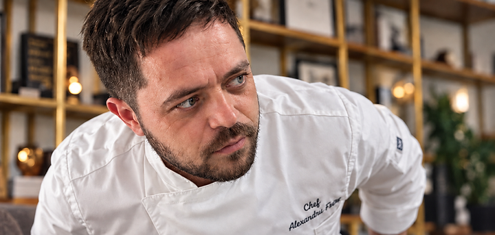 A chef's hands working at a prep station before service