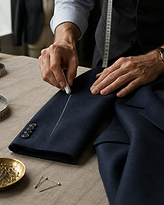Tailor's chalk marking a sleeve crease on a navy blazer
