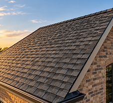 Newly installed charcoal architectural asphalt shingle roof on an upscale Waxhaw home at golden hour