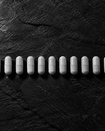 Cycle Ghost Monthly Balance Capsules — black and white studio photograph