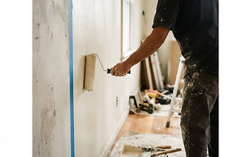 Painting contractor finishing a cut line on an interior wall
