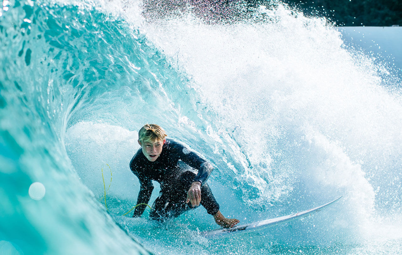 Surfer riding inside a breaking wave