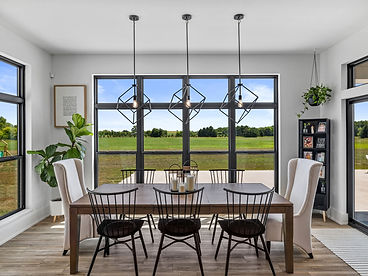 Dining room with a wood table and large windows