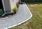 Crushed stone walkway edged with granite block