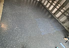 Epoxy coating being rolled out across a garage floor