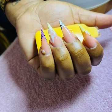 Pointed pastel French tips with zebra accents and delicate flowers