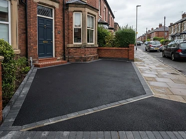 Freshly rolled tarmac with block edge restraints